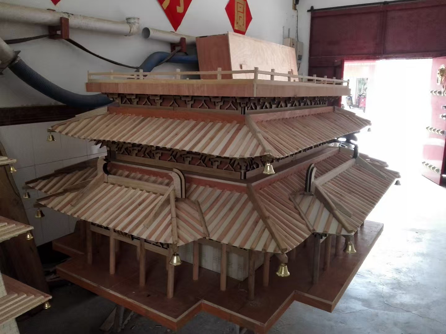 Half-finished wooden Guanque Tower model showing roof and facade details